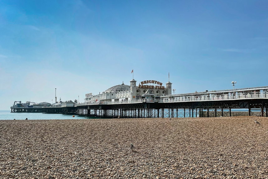 Brighton Palace Pier and the beach under a blue sky, inside the 01273 area
